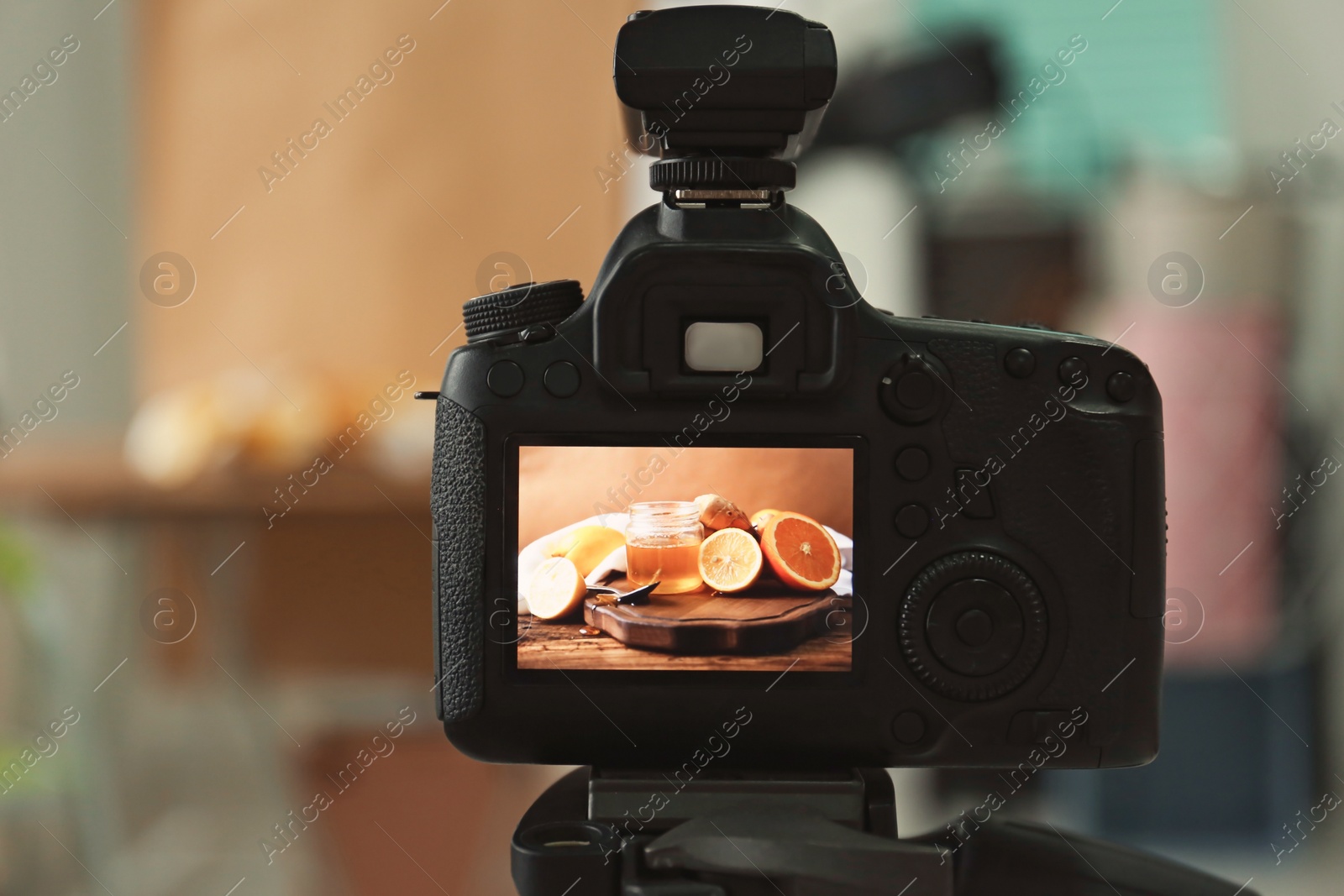 Photo of Professional camera on tripod in studio, closeup. Food photography