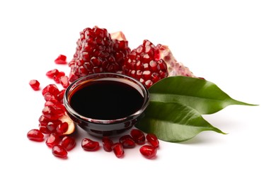 Bowl of pomegranate sauce and fresh ripe fruit on white background