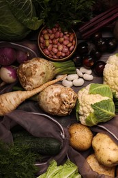 Different fresh ripe vegetables on wooden table, flat lay