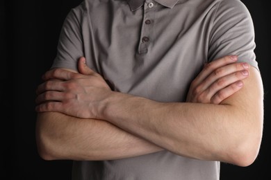 Man with space for tattoo on his arms against black background, closeup