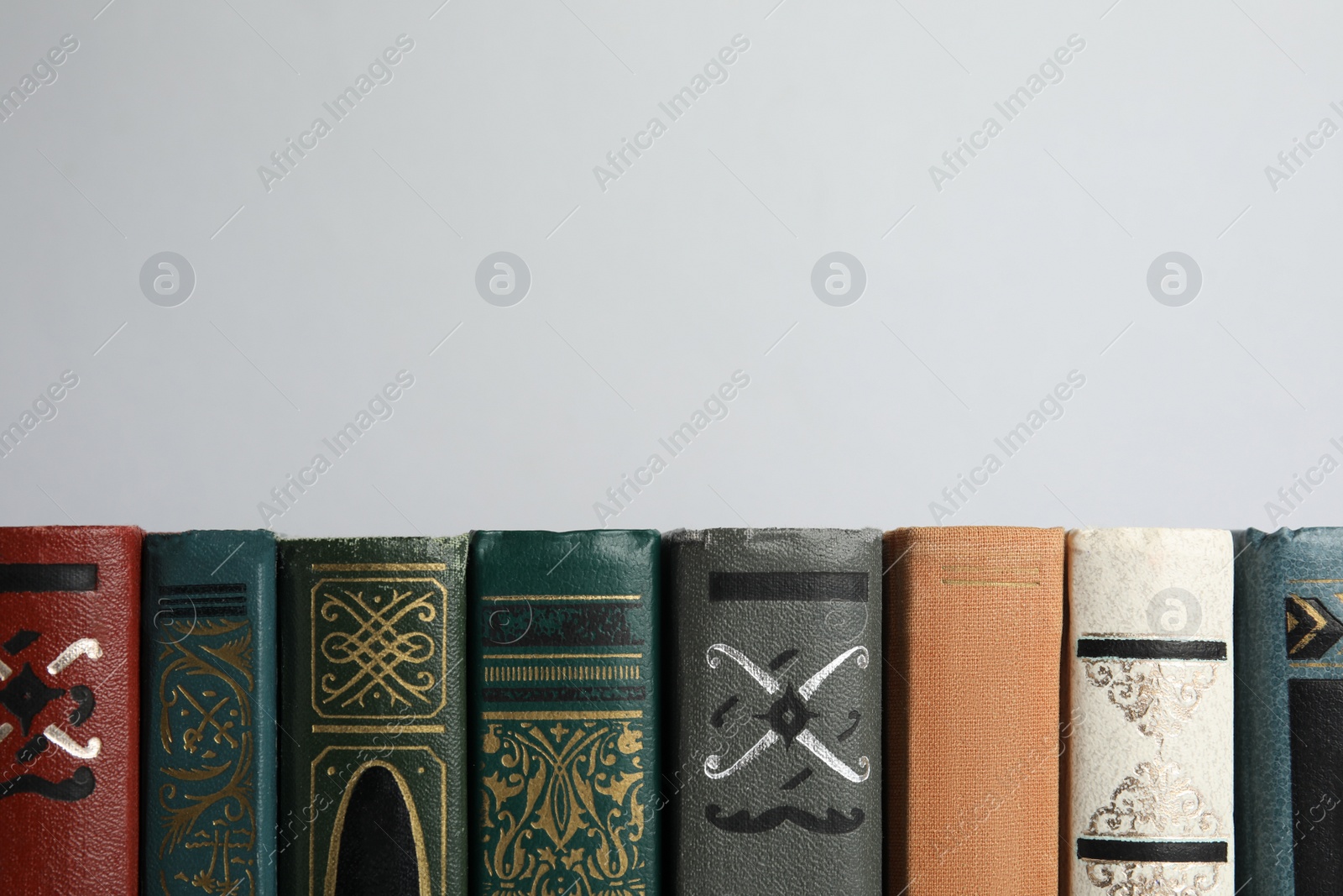 Photo of Collection of old books on light background, space for text