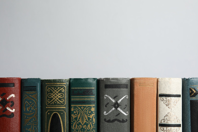 Photo of Collection of old books on light background, space for text