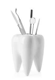 Photo of Tooth shaped holder with professional tools on white background