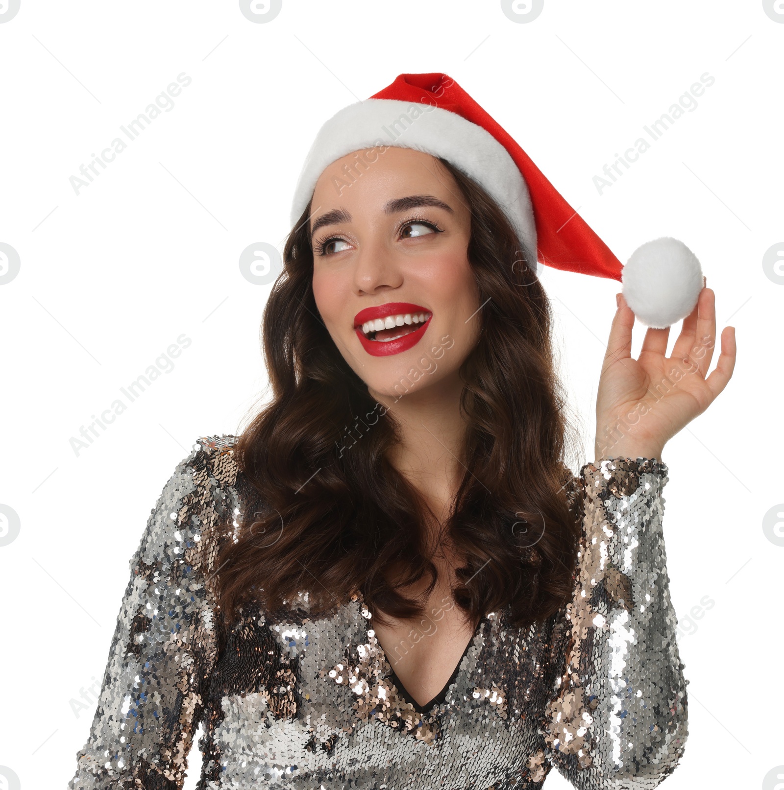 Photo of Christmas celebration. Beautiful young woman in stylish dress and Santa hat isolated on white