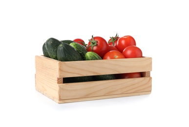 Wooden crate full of fresh vegetables on white background