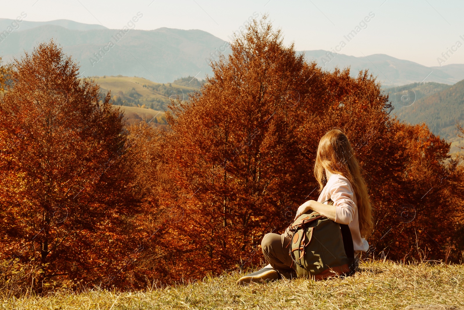 Photo of Woman in warm clothes enjoying mountain landscape