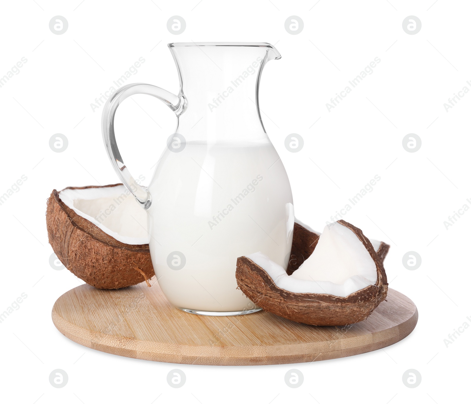 Photo of Glass jug of delicious vegan milk and coconuts on white background