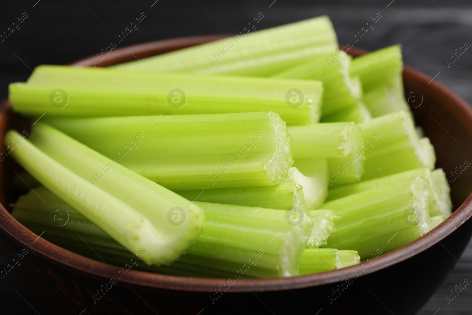 Photo of Fresh cut celery in bowl, closeup view