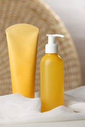 Photo of Bottle and tube of face cleansing products on table