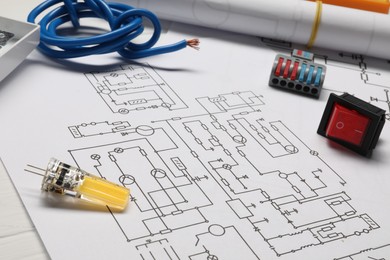 Photo of Wiring diagram, wires and other electrician's equipment on white table