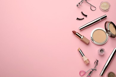 Photo of Eyelash curlers and makeup products on pink background, flat lay. Space for text