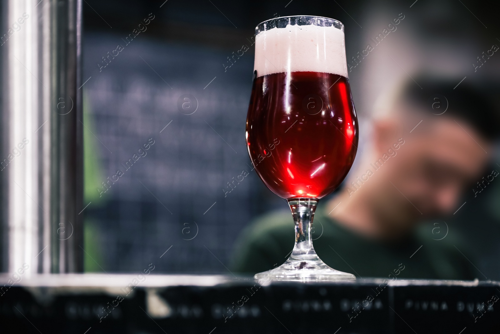 Photo of Glass of beer on bar counter in pub