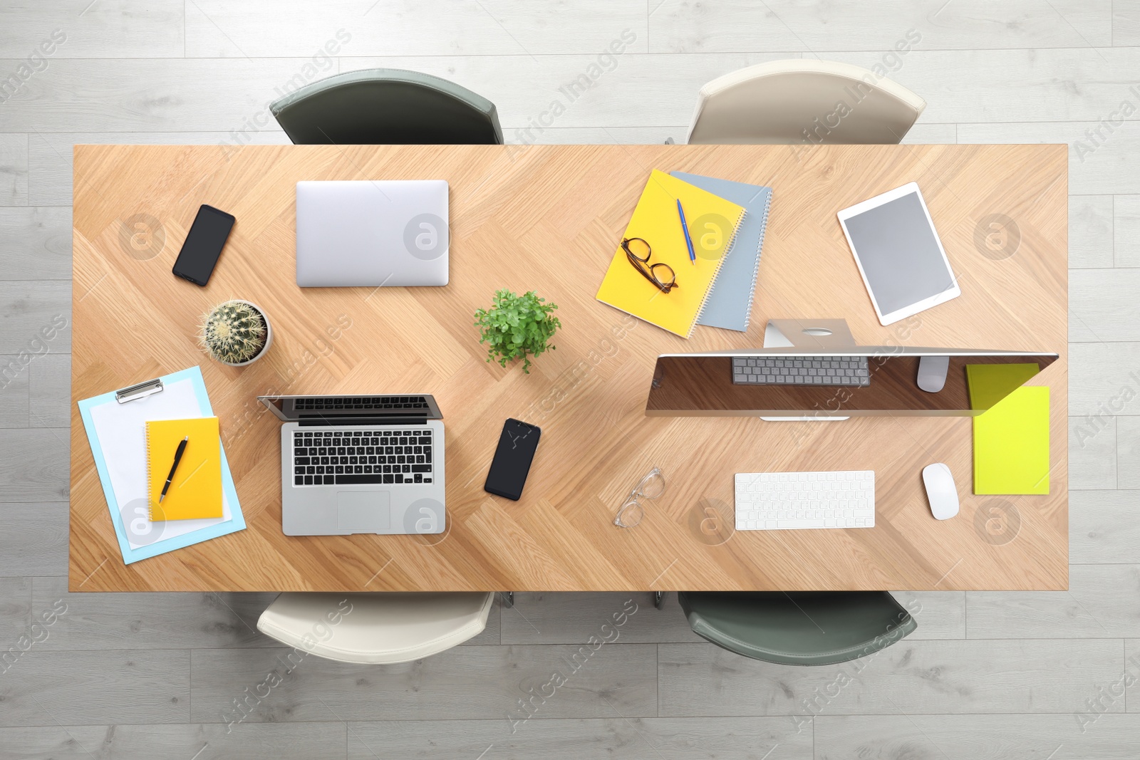 Photo of Modern office table with devices and chairs, top view