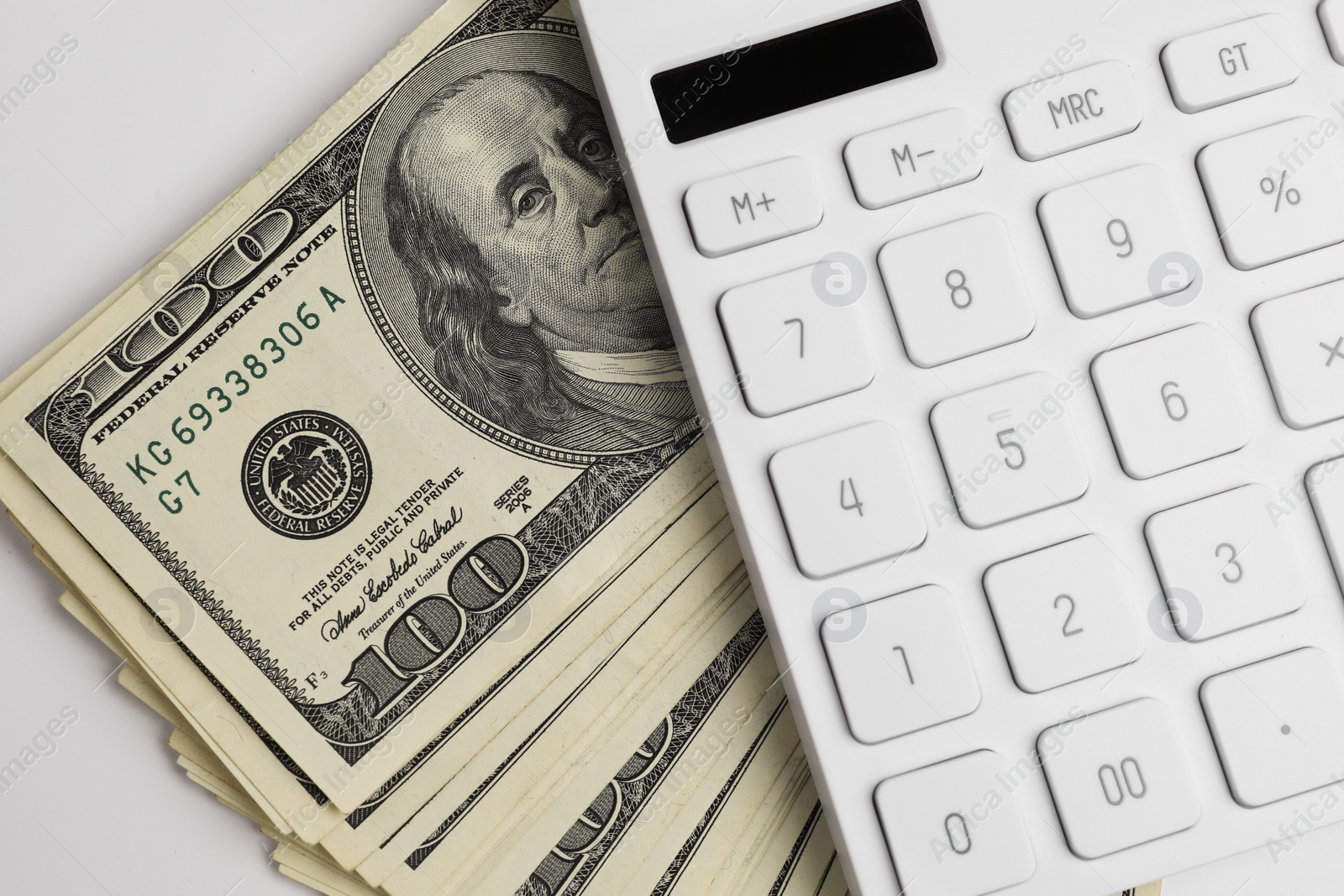 Photo of Money exchange. Dollar banknotes and calculator on white background, top view