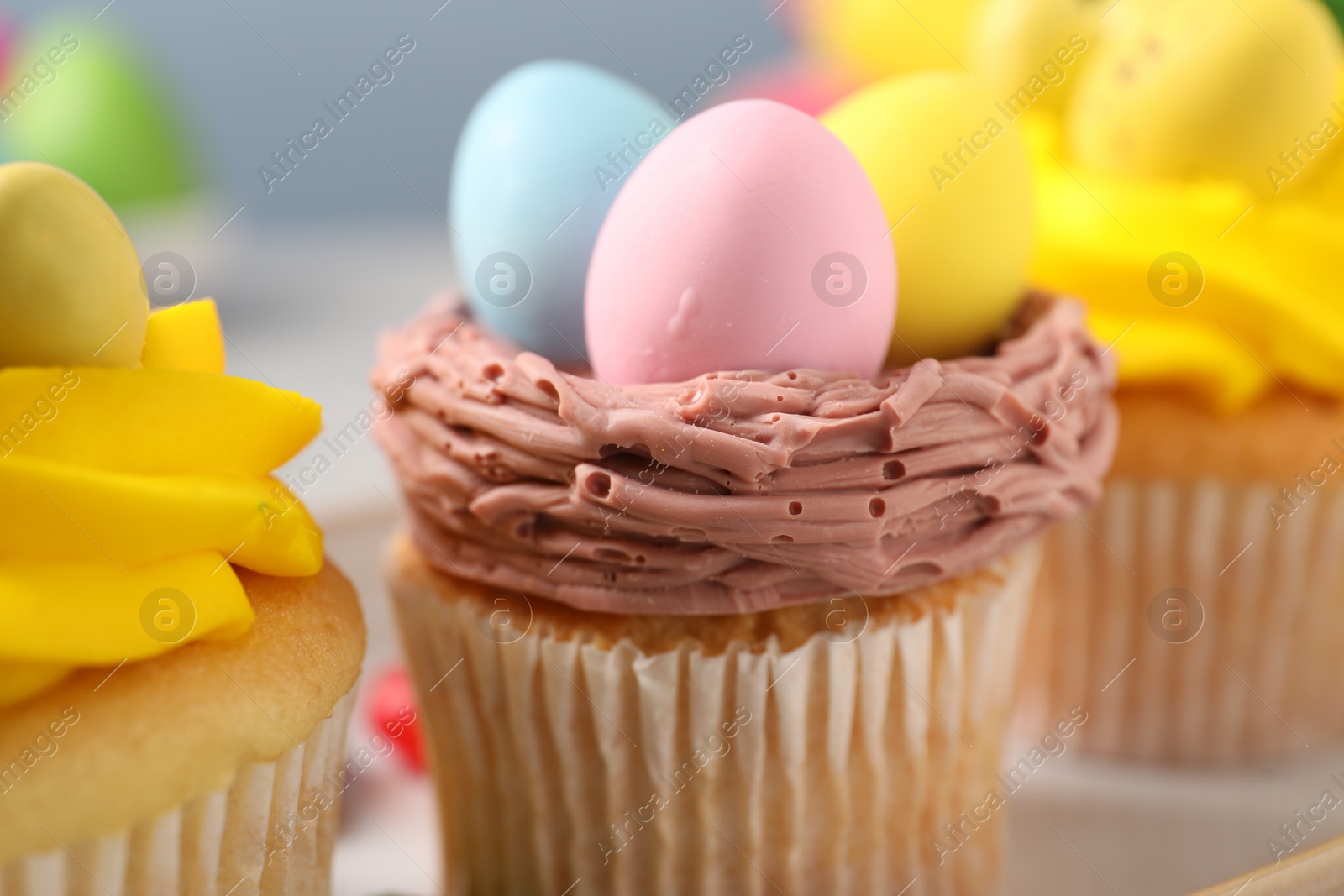 Photo of Tasty decorated Easter cupcakes on table, closeup