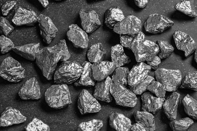 Photo of Many silver nuggets on black table, above view