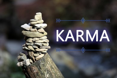 Karma concept. Balancing stones on tree stump in forest