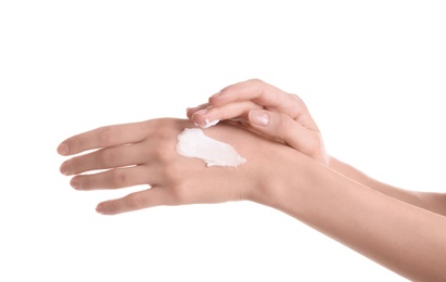 Young woman applying hand cream against on white background