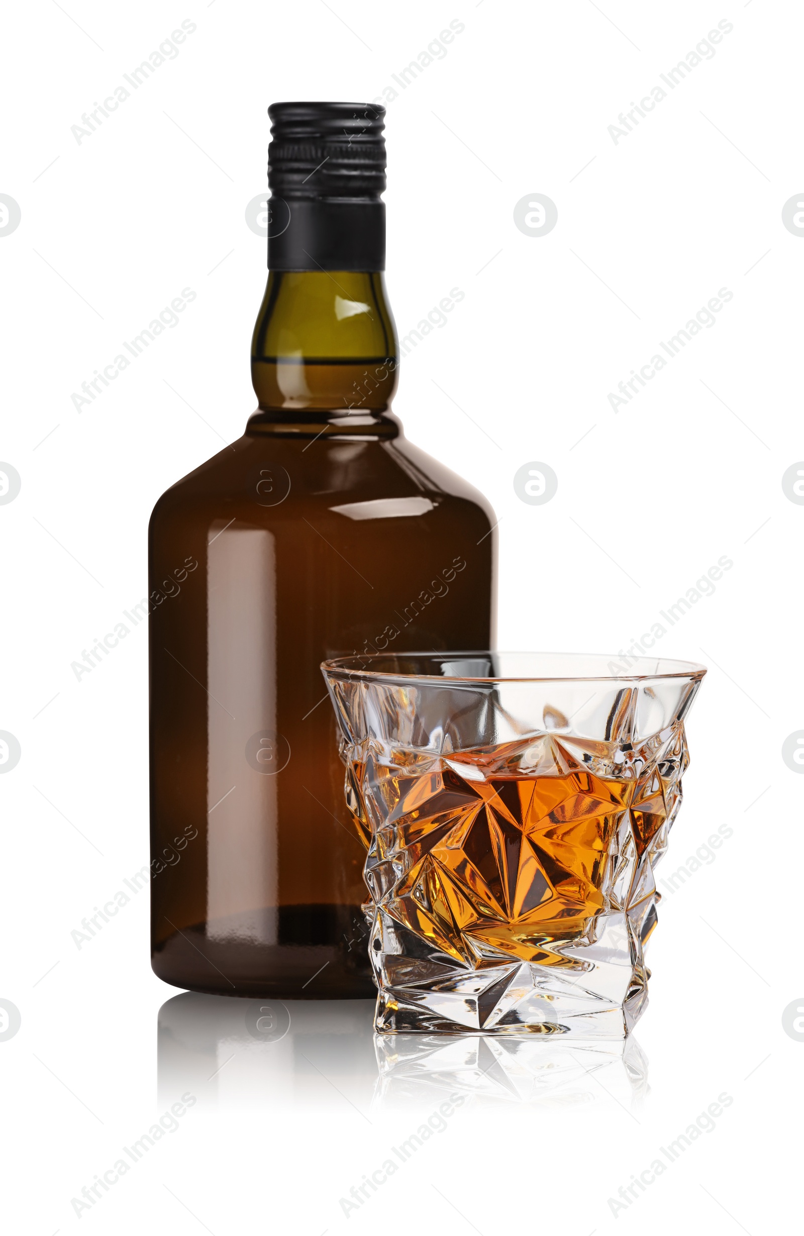 Photo of Glass and bottle of whiskey isolated on white