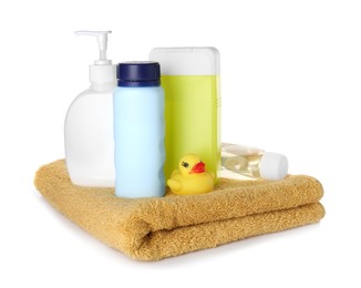 Photo of Bottles of baby cosmetic products, towel and rubber duck on white background