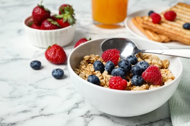 Photo of Tasty breakfast with muesli served on white marble table