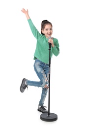 Photo of Little girl singing into microphone on white background