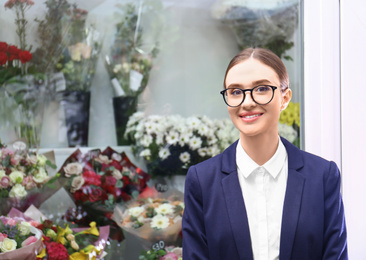 Photo of Portrait of female business owner near flower shop