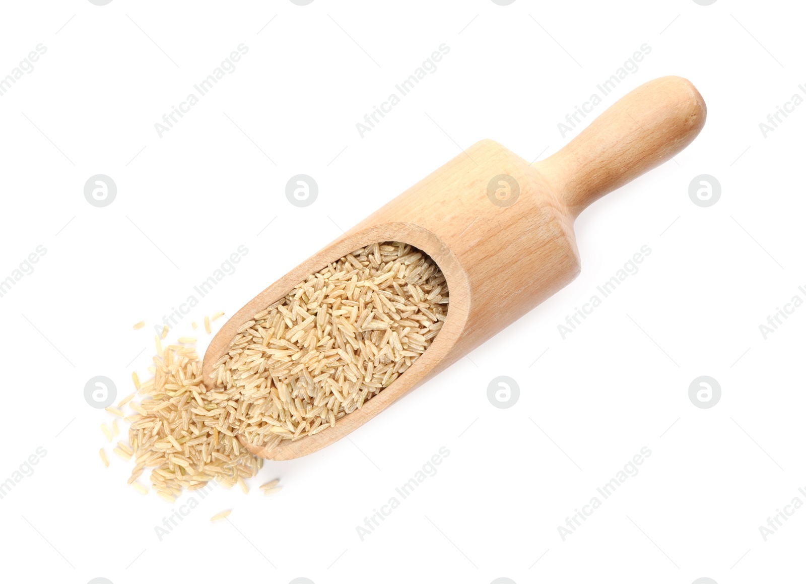 Photo of Wooden scoop with brown rice on white background, top view