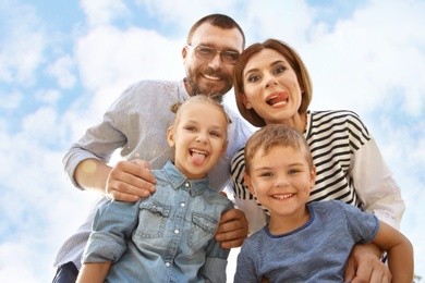Photo of Happy family spending time together with their children outdoors