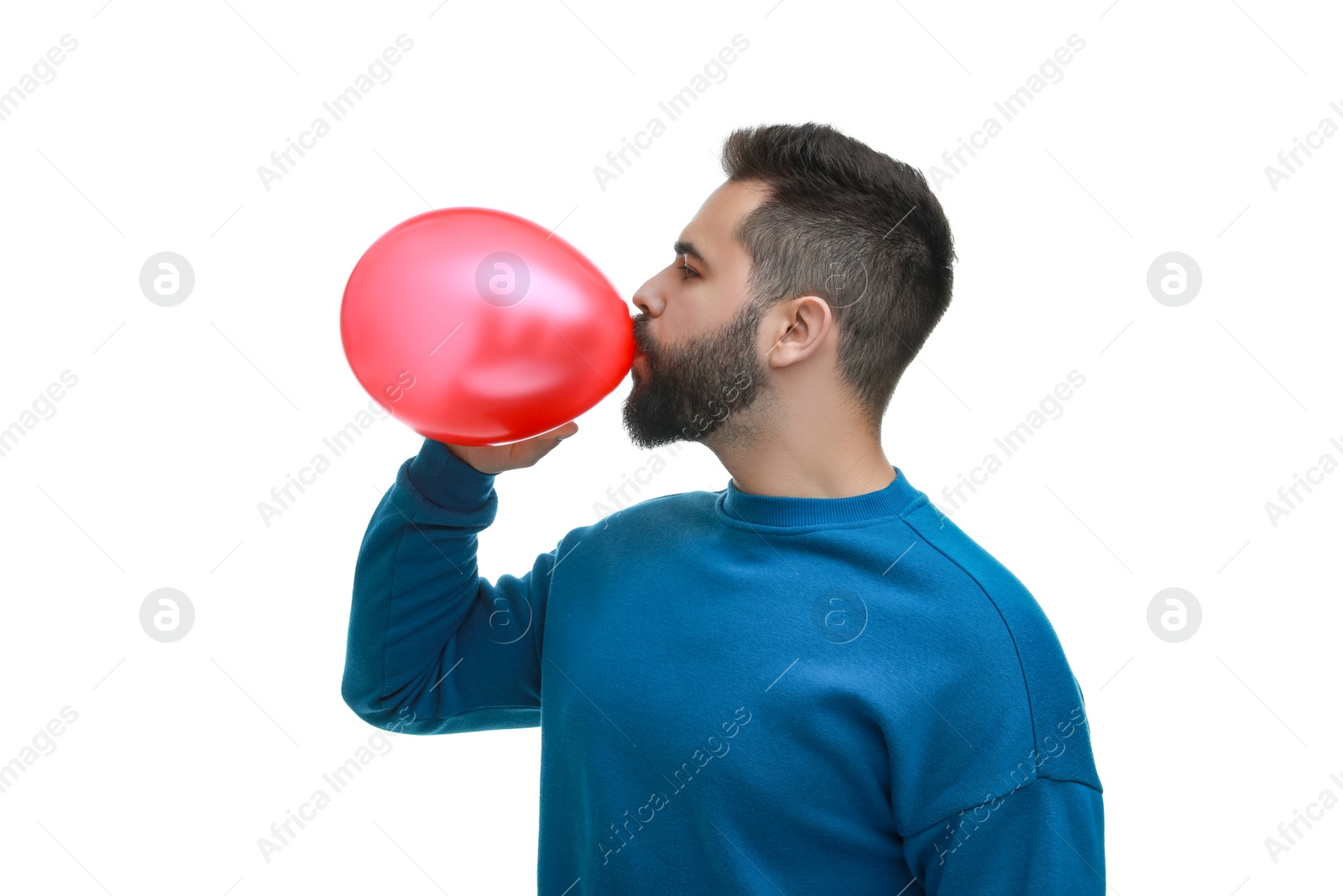 Photo of Man inflating bright balloon on white background