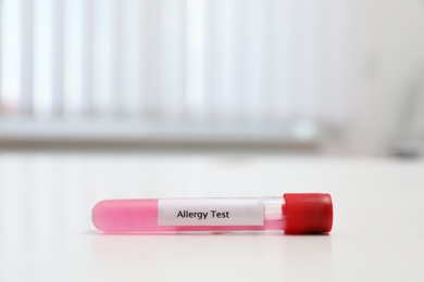 Photo of Tube with label ALLERGY TEST on white table, space for text