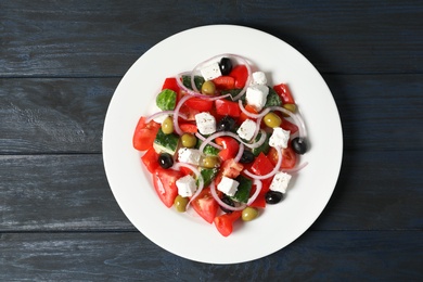 Photo of Plate with delicious salad on table, top view