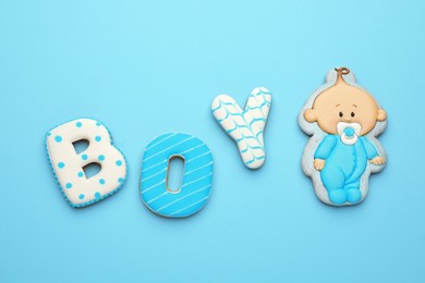Photo of Word BOY made of tasty cookies on light blue background, flat lay with space for text. Baby shower party