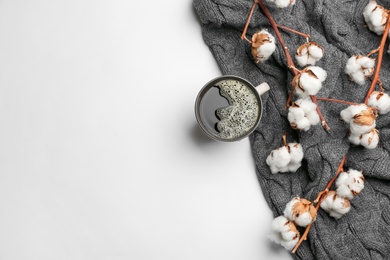 Photo of Flat lay composition with hot drink and warm plaid on white background, space for text