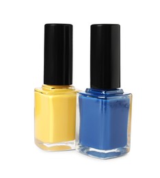 Photo of Bright nail polishes in bottles isolated on white