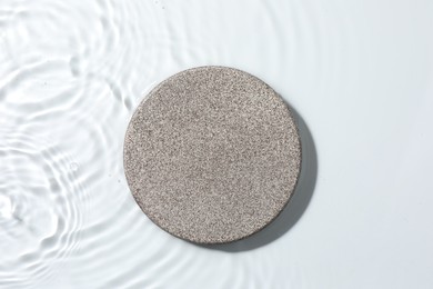 Photo of Presentation for product. Stone podium in water on white background, top view