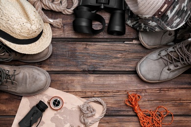 Photo of Flat lay composition with camping equipment on wooden background