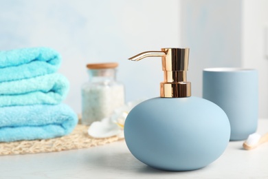 Photo of New stylish soap dispenser on table. Space for text