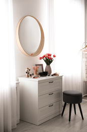 Stylish room interior with dressing table and mirror