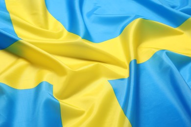 Photo of Flag of Sweden as background, closeup. National symbol