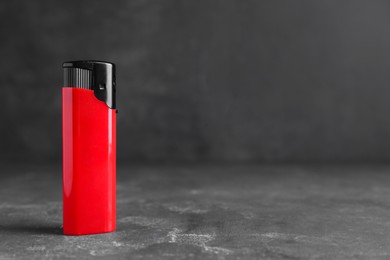 Photo of Stylish small pocket lighter on grey table, space for text