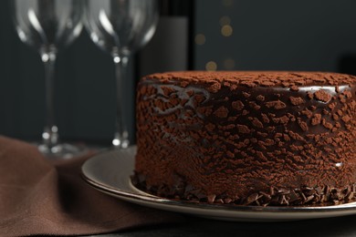 Photo of Delicious chocolate truffle cake on table, closeup