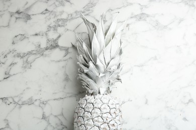 White pineapple on marble background, top view. Creative concept