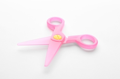 Photo of Colorful plastic scissors on white background. School stationery