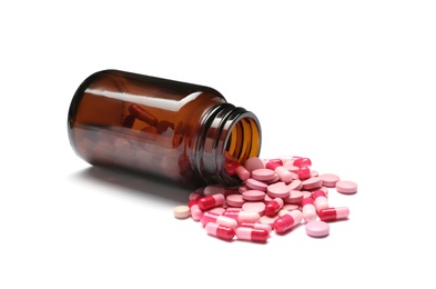 Photo of Bottle with vitamin pills and capsules on white background