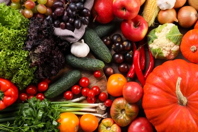 Photo of Different fresh ripe vegetables and fruits on wooden table, flat lay