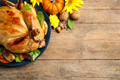 Photo of Traditional cooked turkey and autumn decor on wooden table, flat lay with space for text. Thanksgiving day celebration