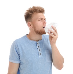 Photo of Young man suffering from allergy on white background