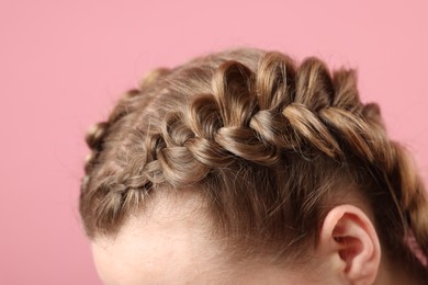 Photo of Woman with braided hair on pink background, closeup