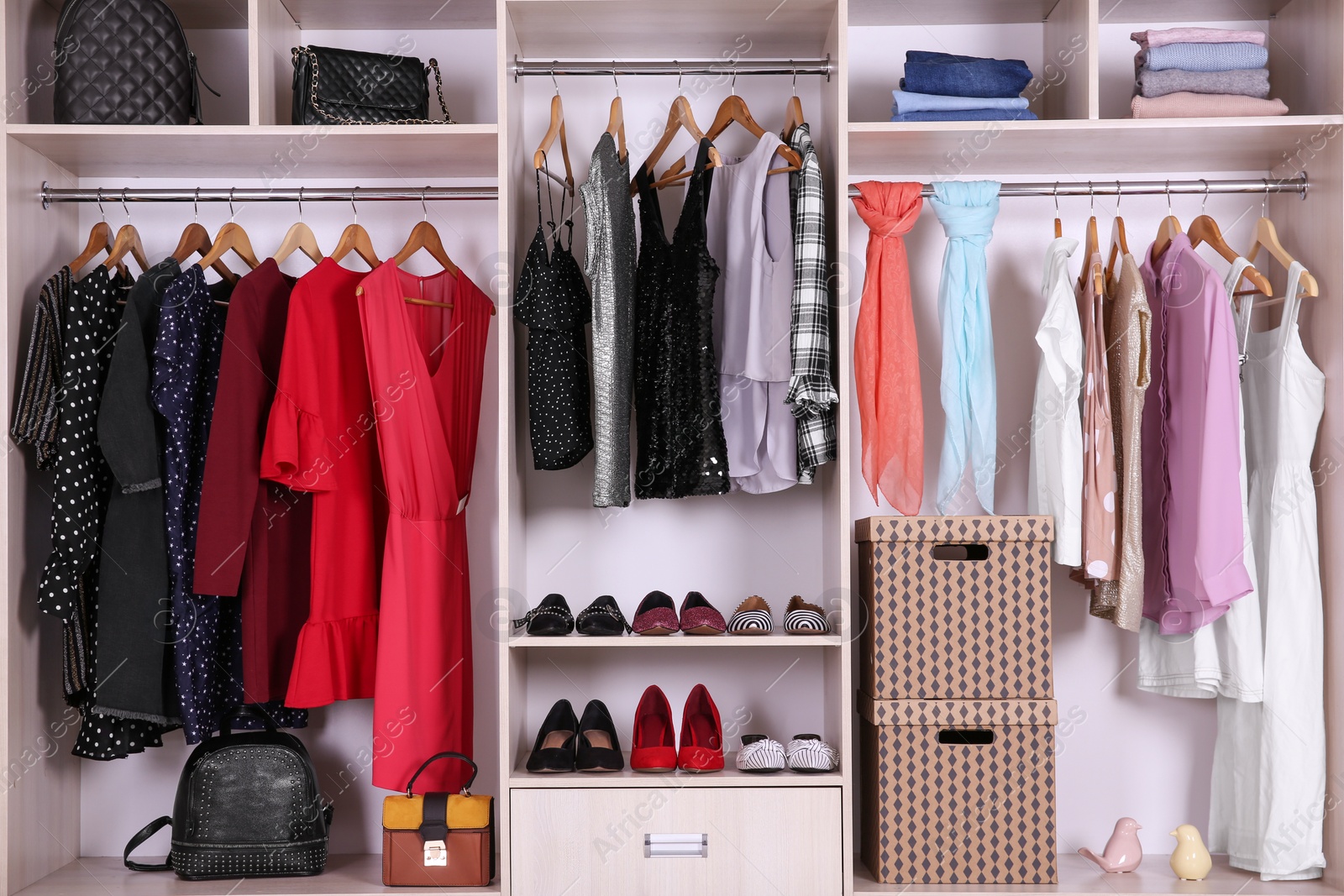 Photo of Large wardrobe with different clothes and shoes